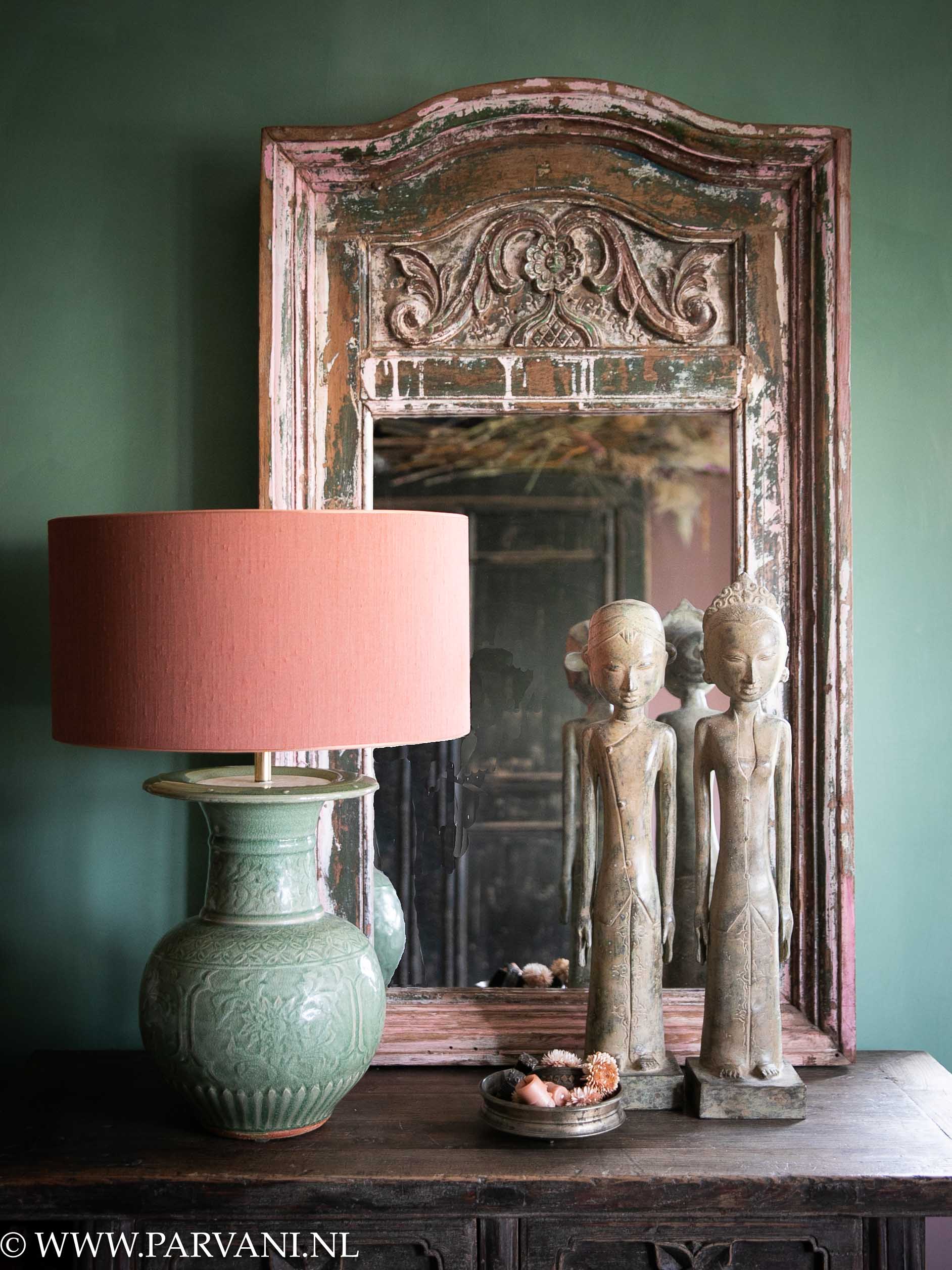 Old Indian Bohemian mirror with green Chinese vaselamp and bronze statues