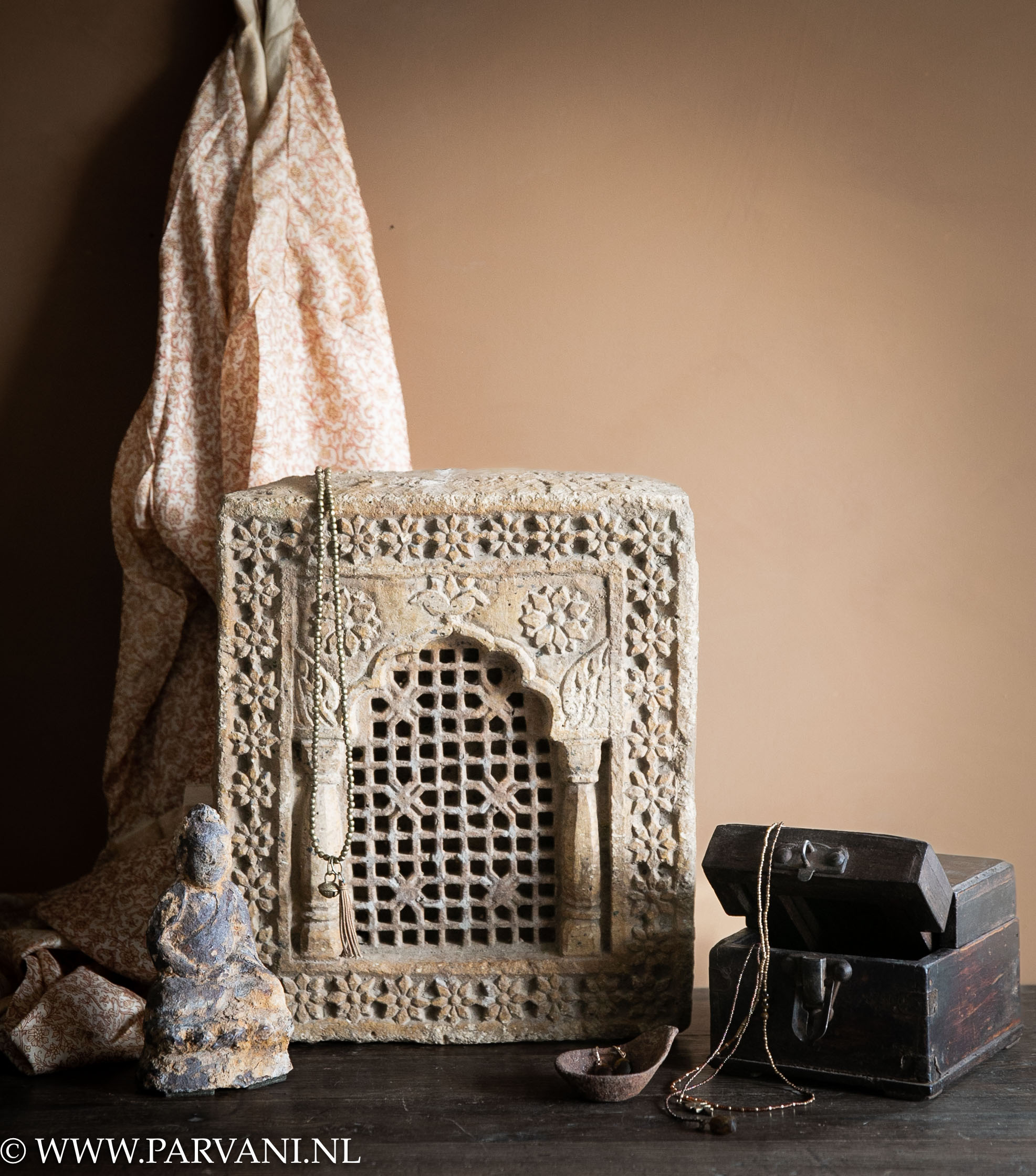 old stone temple ornament from India with beautiful carved pattern, old wooden box, antique buddha statue and silk kimono
